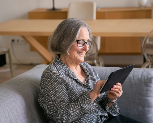 senior lady checking her EZY Drop Shipping profits on her ipad