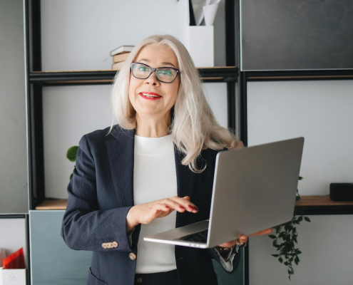 senior lady checking her EZY Drop Shipping profits on her laptop